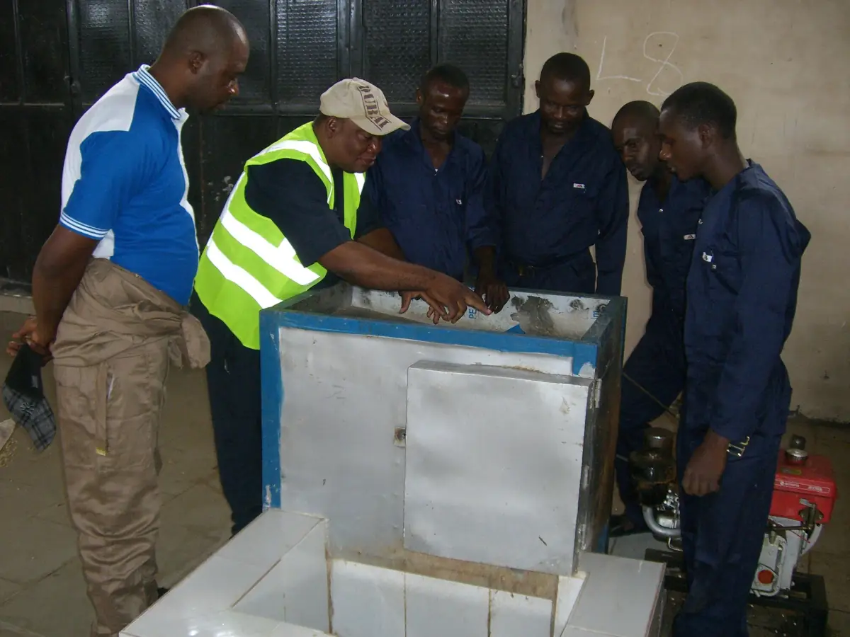 The Osemu-Ehis farm team gathered around processing equipment